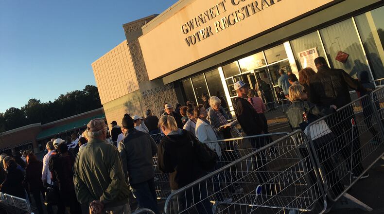 Hundreds of people lined up outside the Gwinnett County elections office Monday morning for the first day of early voting. TYLER ESTEP / TYLER.ESTEP@AJC.COM
