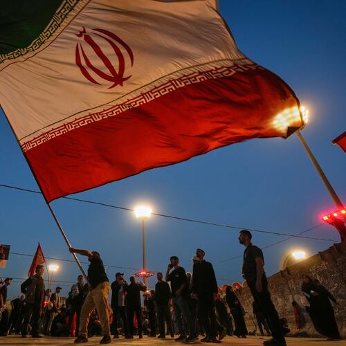 A man waves an Iranian flag during funeral ceremonies for slain Iranian Supreme Leader Ayatollah Ali Khamenei and members of his family at Imam Khomeini Mosalla Grand Mosque in Tehran, Iran, Sunday, July 5, 2026. (AP Photo/Altaf Qadri)