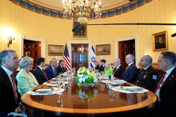 President Donald Trump, fourth from left, meets with Israel's Prime Minister Benjamin Netanyahu, fourth from right, as White House special envoy Steve Witkoff, from left, White House Chief of Staff Susie Wiles, Secretary of State Marco Rubio, Defense Secretary Pete Hegseth, obstructed, CIA Director John Ratcliffe and U.S. Ambassador to Israel Mike Huckabee listen in the Blue Room of the White House, Monday, July 7, 2025, in Washington. (AP Photo/Alex Brandon)