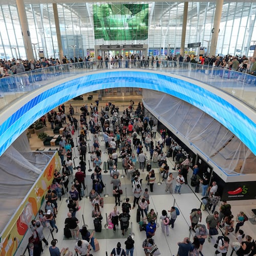 Travelers wait in long security checkpoint lines at George Bush Intercontinental Airport Friday, March 27, 2026, in Houston. (AP Photo/David J. Phillip)