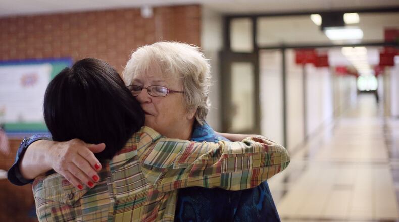 May 28, 2015 - Johnsie Cooper gets a hug from Principal Toni Ferguson on a visit to the school after her retirement. Johnsie Cooper, a second grade teacher at Knight Elementary School in Gwinnett County, retired after 50 years of teaching. AJC FILE PHOTO