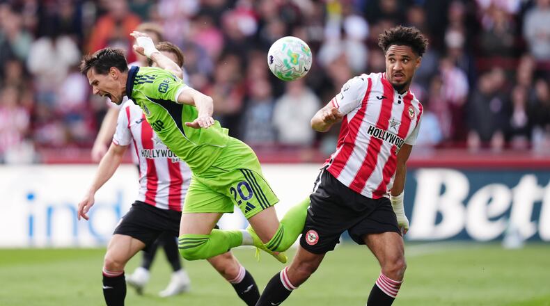 Fulham's Sasa Lukic, left, and Brentford's Kevin Schade battle for the ball during the English Premier League soccer match between Brentford and Fulham in Brentford, England, Saturday April 18, 2026. (John Walton/PA via AP)
