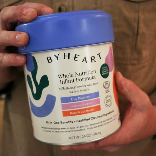 Stephen Dexter holds a container of ByHeart baby formula, which was recently recalled by ByHeart, in Flagstaff, Ariz., on Wednesday, Nov. 12, 2025. (AP Photo/Cheyanne Mumphrey)