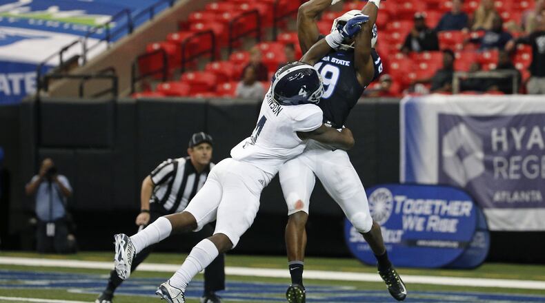 Georgia State wide receiver Robert Davis catches a touchdown against Georgia Southern cornerback Monquavion Brinson at the Georgia Dome on Saturday. PHOTO / JASON GETZ