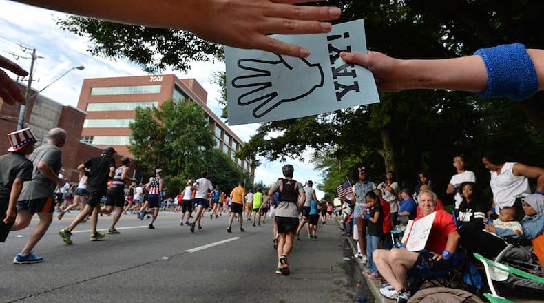 AJC Peachtree Road Race runners get support from the crowds.