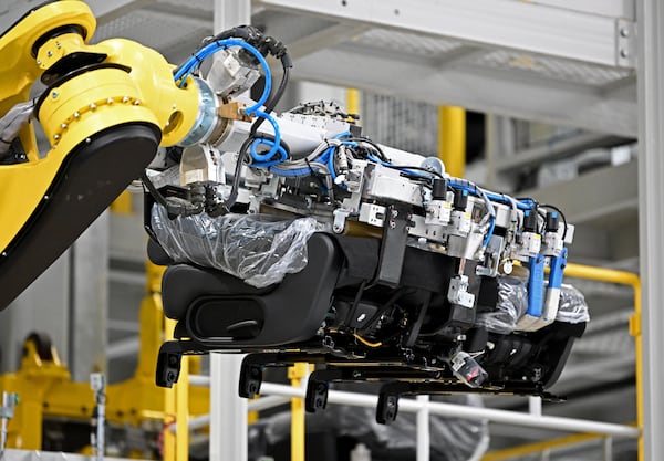 A robot installs a car seat on the assembly line at Hyundai Motor Group Metaplant America (HMGMA) in Ellabell on Wednesday, May 6, 2026. (Hyosub Shin/AJC)