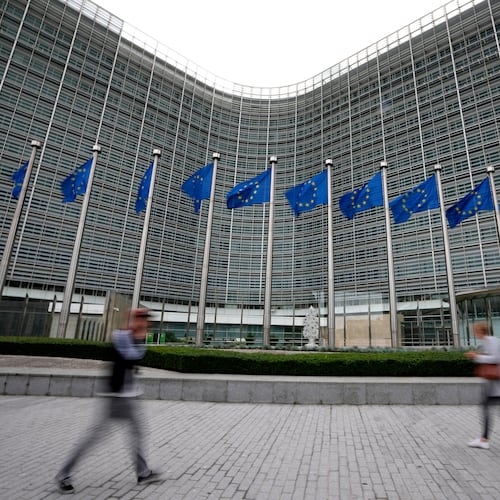 FILE - European Union flags flap in the wind as pedestrians walk by EU headquarters in Brussels, Wednesday, Sept. 20, 2023. (AP Photo/Virginia Mayo, File)