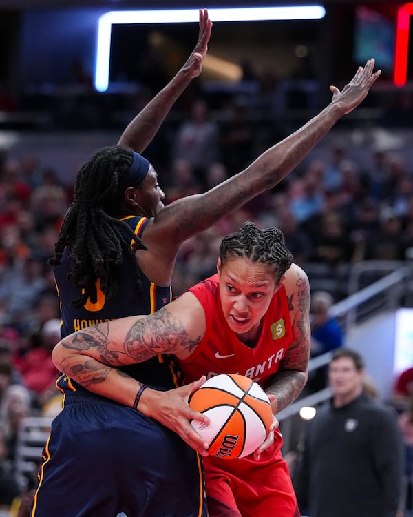Atlanta Dream center Brittney Griner (42) tries to go around Indiana Fever forward Natasha Howard (6) in the second half of a WNBA basketball game in Indianapolis, Tuesday, May 20, 2025. (AP Photo/Michael Conroy)