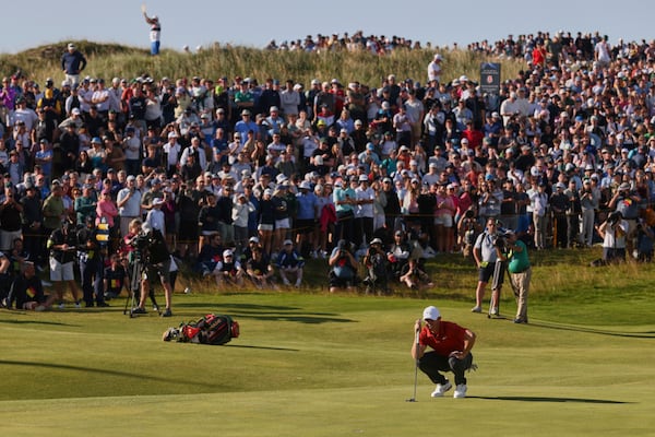 Rory McIlroy of Northern Ireland looks at the line of his putt on the 17th hole during the third round of the British Open golf championship at the Royal Portrush Golf Club, Northern Ireland, Saturday, July 19, 2025. (AP Photo/Peter Morrison)