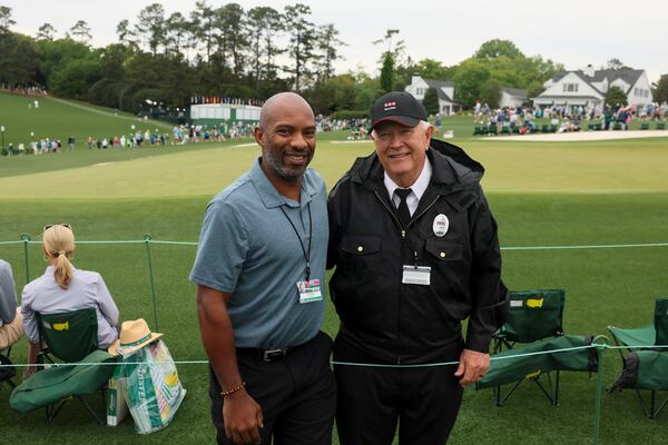 AJC Senior Sports Editor Rod Beard poses for a photograph with Masters security guard Steve Lankford on the ninth green during a practice round at the Masters golf tournament Monday, April 6, 2026 in Augusta. (Jason Getz/AJC) 