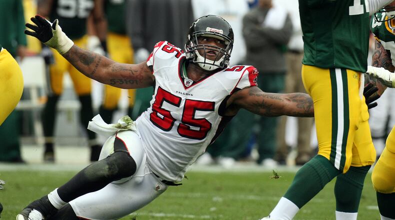 Falcons defensive end John Abraham comes in low with an all out rush to tackle Packers quarterback Aaron Rodgers during second half action on historic Lambeau Field, Sunday, Oct. 5, 2008.      Curtis Compton / ccompton@ajc.com