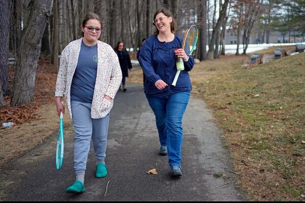 Iris Turmelle walks with her mom, Amy Manzelli, near her high school's tennis courts, Wednesday, March 5, 2025, in Pembroke, N.H. (AP Photo/Robert F. Bukaty)
