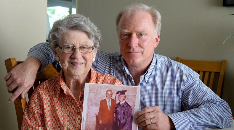 Jackie McKinley, 88, and her son Mark Fridell, 59, hold a photograph showing her late husband Lee Fridell, and Mark at his 1974 Campolindo High School Graduation as they pose in her home on May 11, 2016 in Danville, Calif.  (Susan Tripp Pollard/Bay Area News Group/TNS)