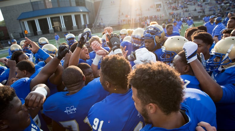 McEachern huddles during warmups prior to the game against Buford at Walter H. Cantrell Stadium in Powder Springs, Ga. on Friday, Sept. 4, 2015. (Kevin Liles/AJC)