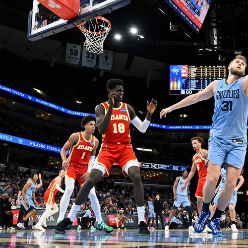Grizzlies center Jock Landale (right) reaches for the ball ahead of Hawks forward Mouhamed Gueye (center) on Wednesday, Jan. 21, 2026, in Memphis, Tenn. On Wednesday, the Hawks acquired Landale, who is averaging a career-high 11.3 points this season. (Brandon Dill/AP)