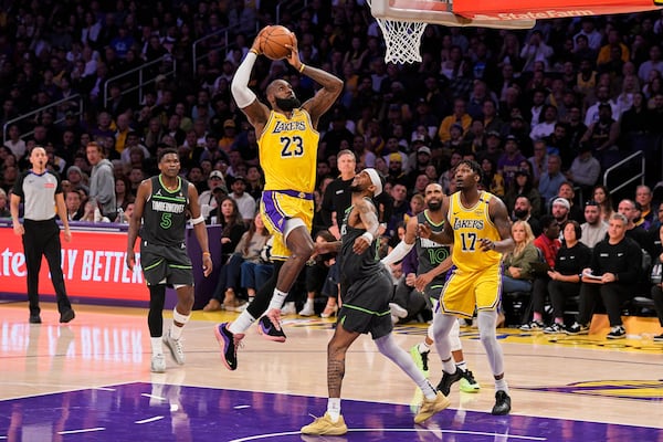FILE - Los Angeles Lakers forward LeBron James (23) shoots as Minnesota Timberwolves guard Nickeil Alexander-Walker (9) defends during the first half in Game 5 of an NBA basketball first-round playoff series Wednesday, April 30, 2025, in Los Angeles. (AP Photo/Mark J. Terrill, File)