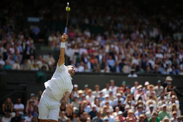 Daniel Evans of Britain serves to Novak Djokovic of Serbia during their second round men's singles match at the Wimbledon Tennis Championships in London, Thursday, July 3, 2025. (AP Photo/Alastair Grant)