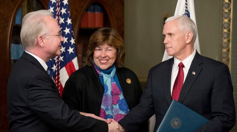 Vice President Mike Pence shakes hands with Health and Human Services Secretary Tom Price, accompanied by his wife Betty, after a swearing-in ceremony last February. AP/Andrew Harnik