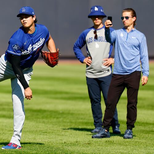 Los Angeles Dodgers' Shohei Ohtani, left, throws in the outfield before the second game of a baseball doubleheader against the New York Yankees, Sunday, July 19, 2026, in New York. (AP Photo/Noah K. Murray)
