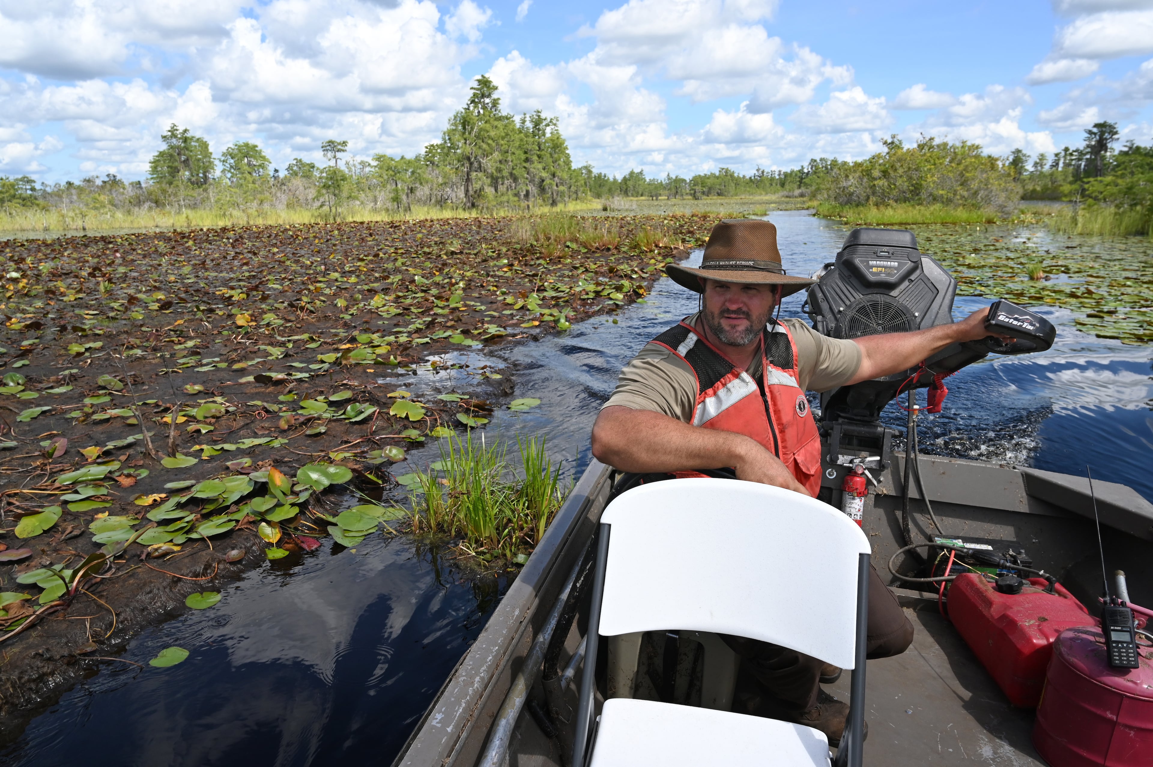 U.S. Fish and Wildlife Service employee Zach Carter cruises through the Okefenokee Swamp in August. (Hyosub Shin/AJC)
