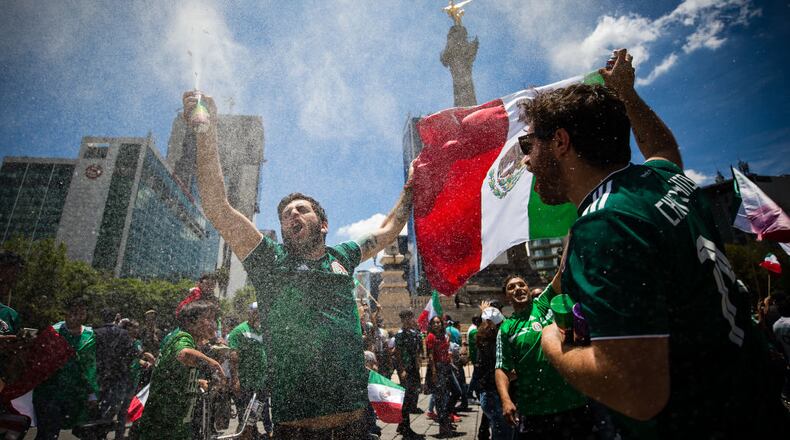 MEXICO CITY, MEXICO - JUNE 17: Mexicans celebrate at the Angel of Independence after the Mexico National Team victory over Germany in the 2018 FIFA World Cup Russia on June 17, 2018 in Mexico City, Mexico. (Photo by Manuel Velasquez / Getty Images)