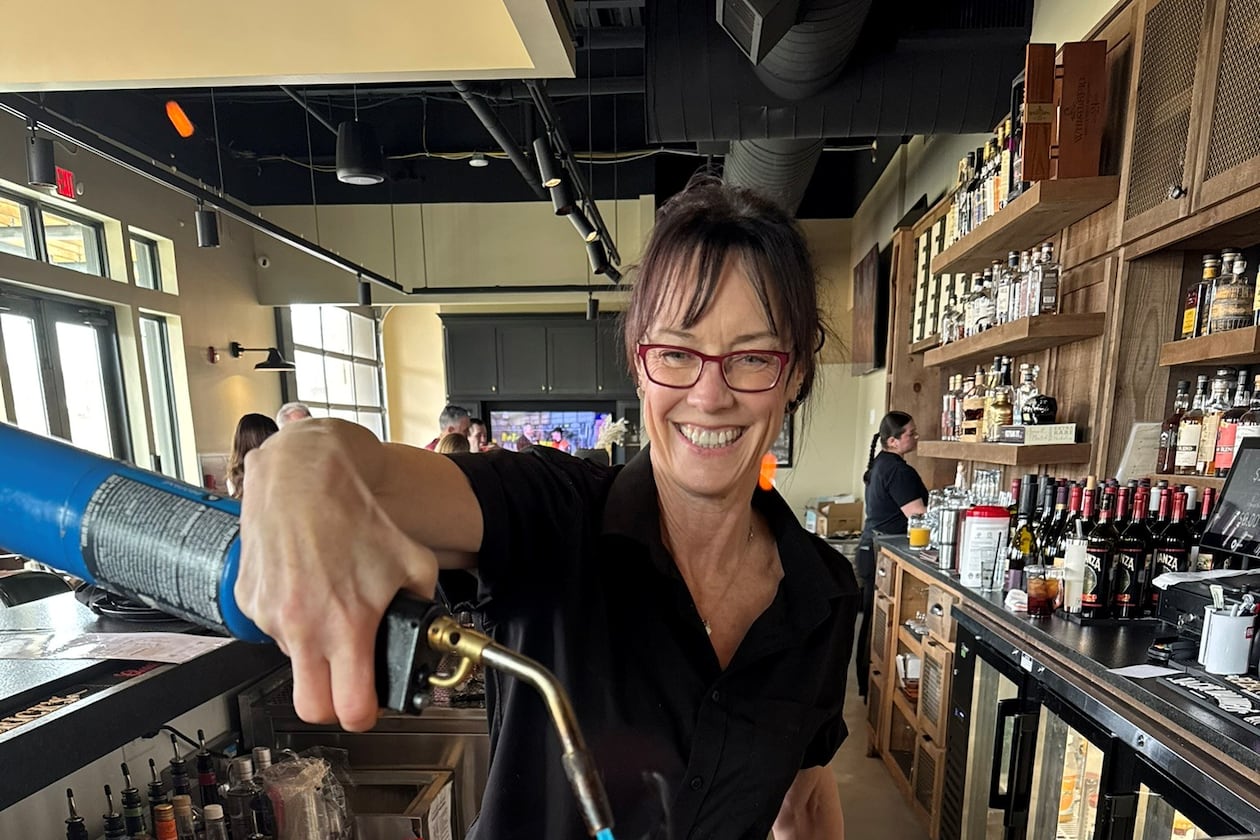 Beth Minor, 60, returned to her hospitality roots as a bartender at Rosati's Pizza at Cumming City Center while searching for her next full-time career move. She had been laid off from her corporate role. Photo courtesy of Beth Minor)