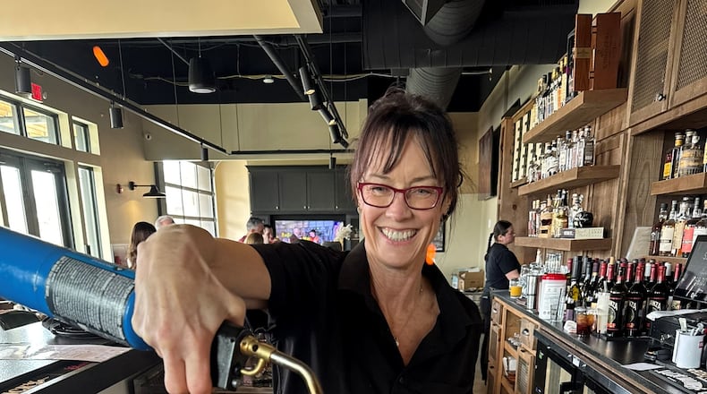 Beth Minor, 60, returned to her hospitality roots as a bartender at Rosati's Pizza at Cumming City Center while searching for her next full-time career move. She had been laid off from her corporate role. Photo courtesy of Beth Minor)