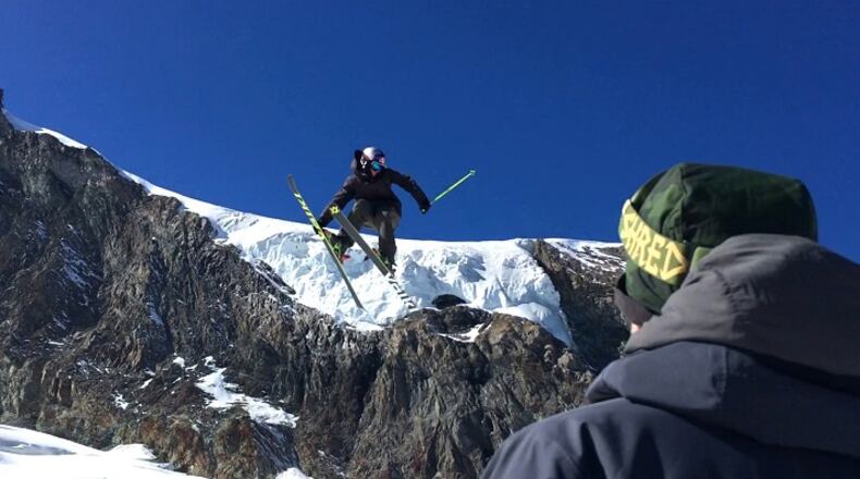 This photo taken from a 4K video and dated Wednesday, Oct. 18, 2017 shows a skier performing a jump during training on the glacier above Saas-Fee, Switzerland. The glacier attracted skiers and snowboard athletes from an array of nations, who came hunting for snow on which to train early in the season ahead of the 2018 Pyeongchang Olympics. (AP Photo/John Leicester)