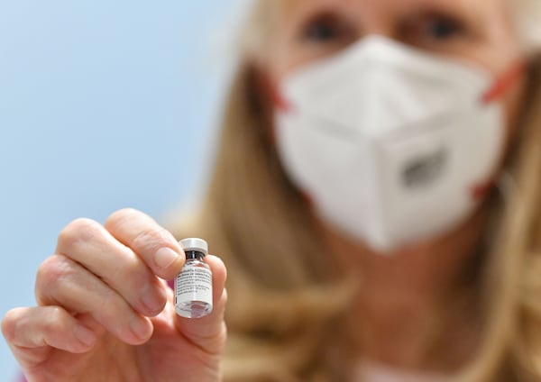 In this file photo, Robin Coffey, a registered nurse with Whitfield Board of Health, holds a Pfizer-BioNtech COVID-19 vaccine at the Whitfield County Health Department in Dalton. (Hyosub Shin / Hyosub.Shin@ajc.com)