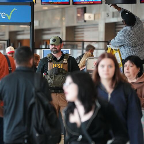 A federal officer, stands at a Transportation Security Administration (TSA) checkpoint at Philadelphia International Airport in Philadelphia, Friday, March 27, 2026. (AP Photo/Matt Rourke)