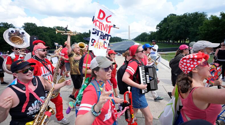 A group of local activist from Washington DC, demonstrating during the March on Washington rally at the Lincoln Memorial on the National Mall, Friday, Aug. 28, 2026 in Washington. (AP Photo/Manuel Balce Ceneta)