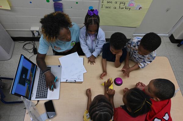 Cassandra Boatwright helps pre-K students at the DeKalb Early Learning Center on Wednesday, April 1, 2026, in Atlanta. The DeKalb County School District is considering adding more early learning centers. (Hyosub Shin/AJC)