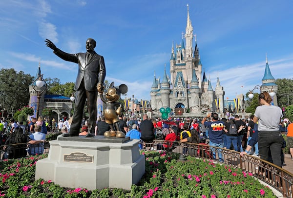 FILE - A statue of Walt Disney and Micky Mouse stands in front of the Cinderella Castle at the Magic Kingdom at Walt Disney World in Lake Buena Vista, Fla., Jan. 9, 2019. (AP Photo/John Raoux, File)