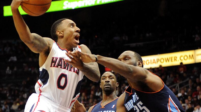 Atlanta Hawks guard Jeff Teague (0) is fouled by Charlotte Bobcats' Al Jefferson (25) in the first half of their NBA basketball game on Saturday, Dec. 28, 2013, in Atlanta. (AP Photo/David Tulis)