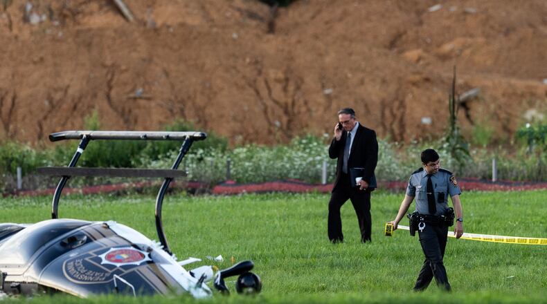 Authorities investigate a crash between a Pennsylvania State Police helicopter and a small plane at the Carlisle airport in Carlisle, Pa. Wednesday, Aug. 19, 2026. (Sean Simmers/The Patriot-News via AP)