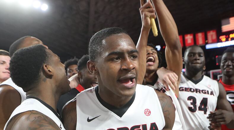 Georgia guard Jordan Harris and teammates celebrate an earlier victory over Florida this season. Curtis Compton/ccompton@ajc.com