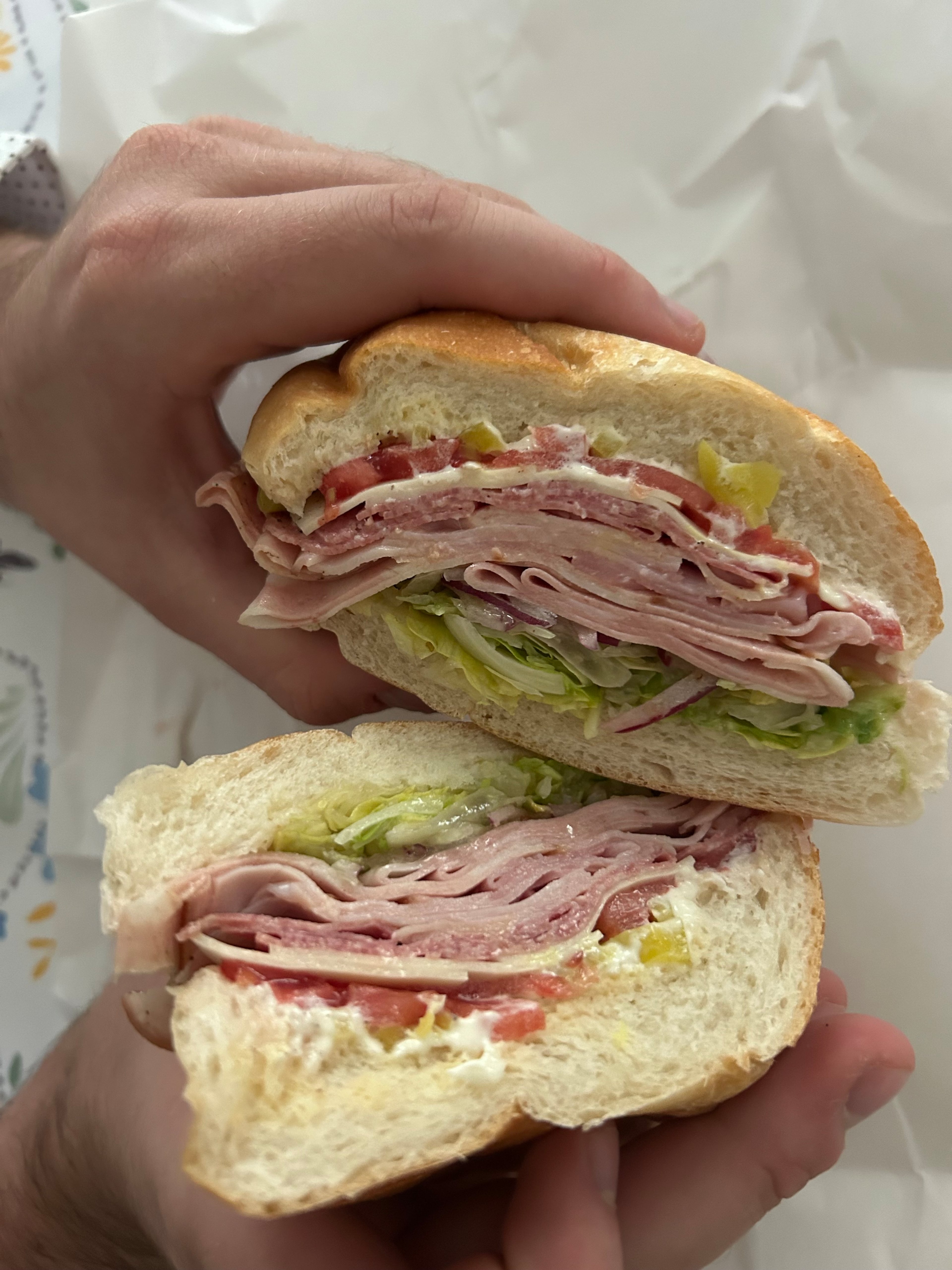 A cross-section of the Samborghini sandwich from Sammy's, complete with fresh bolillo, ham, mortadella, salami and provolone. (Olivia Wakim/AJC)