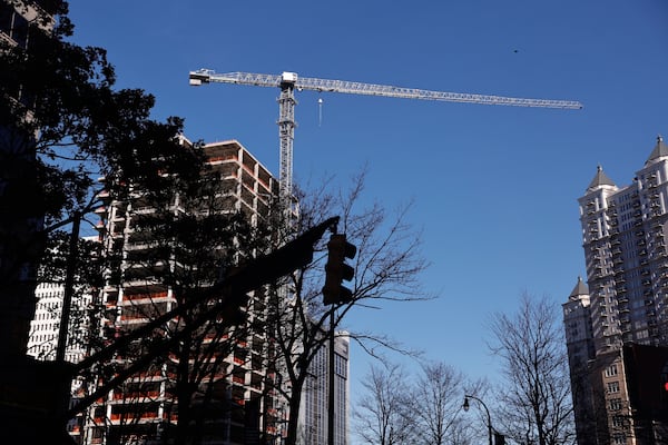 A construction crane looms over Midtown. (Natrice Miller/AJC)