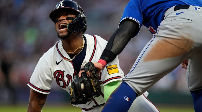 FILE - Atlanta Braves' Ronald Acuña Jr. (13) steals third base against Toronto Blue Jays third baseman Kazuma Okamoto (7) in the fifth inning of a baseball game on June 3, 2026, in Atlanta. (AP Photo/Mike Stewart, File)