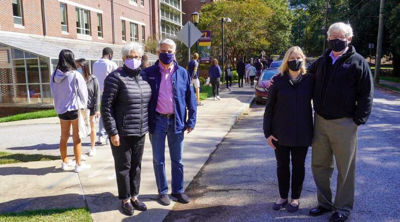Emory University President Gregory Fenves, wearing blue jeans, and his wife, Carmel Martinez Fenves, join Agnes Scott College President Leocadia "Lee" Zak, and her husband, Kenneth Hansen, as some Emory students waited in line for early voting on the Agnes Scott campus. PHOTO CREDIT: Agnes Scott College and Emory University.