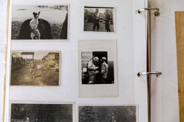 Photographs and documents from Avery Low's World War II service are displayed in a scrapbook at his home. Low preserved letters, photographs and military memorabilia from his time in Europe. (Walker Smith for the AJC)