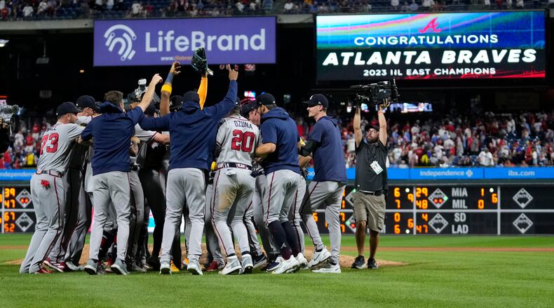 Atlanta Braves players and coaches celebrate after clinching their sixth consecutive NL East title by defeating the Philadelphia Phillies in a baseball game, Wednesday, Sept. 13, 2023, in Philadelphia. (AP Photo/Matt Slocum)