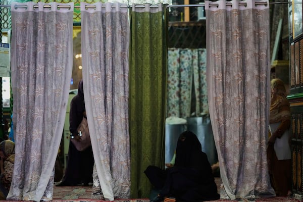 A Kashmiri Muslim woman prays inside the shrine of Sheikh Abdul Qadir Jeelani, commonly known as Dastageer Sahib, in Srinagar, Indian controlled Kashmir, Wednesday, April 2, 2025. (AP Photo/Mukhtar Khan)