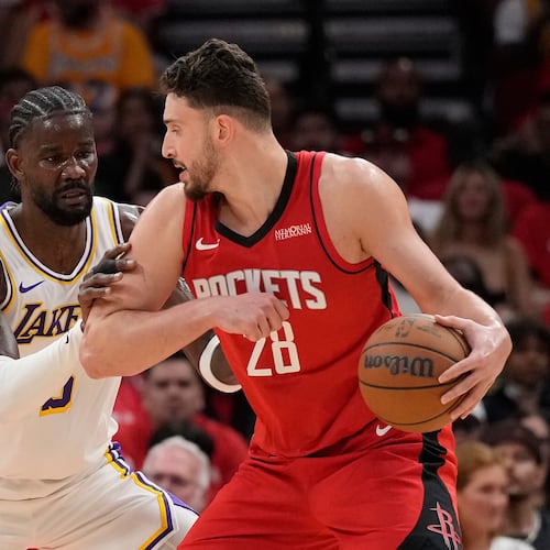 Houston Rockets center Alperen Sengun (28) controls the ball against Los Angeles Lakers center Deandre Ayton (5) during the first half in Game 4 of a first-round NBA basketball playoffs series, Sunday, April 26, 2026, in Houston. (AP Photo/Karen Warren)