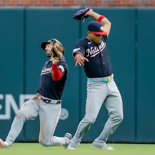 Washington Nationals second baseman José Tena, right, catches fly ball hit by Atlanta Braves catcher Joey Bart, as Nationals right fielder Dylan Crews avoids a collision during the second inning of a baseball game, Friday, July 31, 2026, in Atlanta. (AP Photo/Erik S. Lesser)