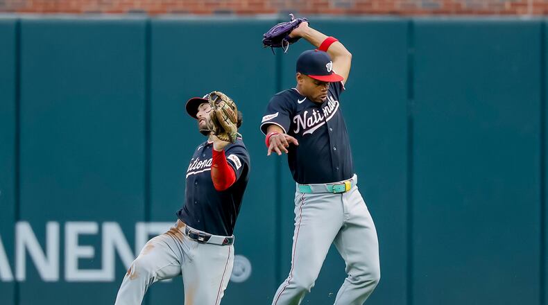 Washington Nationals second baseman José Tena, right, catches fly ball hit by Atlanta Braves catcher Joey Bart, as Nationals right fielder Dylan Crews avoids a collision during the second inning of a baseball game, Friday, July 31, 2026, in Atlanta. (AP Photo/Erik S. Lesser)
