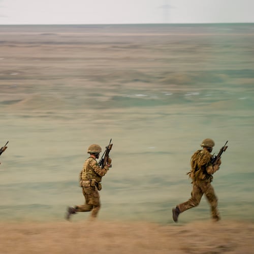 FILE- Servicemen run during the Steadfast Dart 2025 exercise, involving some 10,000 troops in three different countries from nine nations, representing the largest NATO operation planned this year, at a training range in Smardan, eastern Romania, Wednesday, Feb. 19, 2025. (AP Photo/Vadim Ghirda, file)