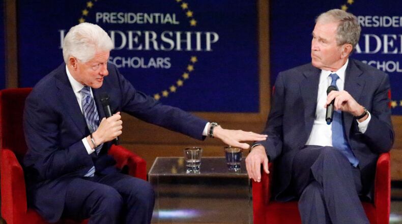Former U.S. presidents Bill Clinton (L) and George W. Bush respond to questions at the Presidential Leadership Scholars graduation ceremony at the George W. Bush Institute on July 13, 2017 in Dallas, Texas. The organization brings together leaders from non-profits, the military and public and private sectors for programs in leadership. (Photo by Stewart F. House/Getty Images)