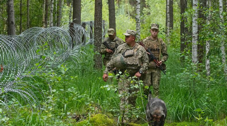 Ukrainian border guards patrol Ukraine-Belarus border in an undisclosed location in Ukraine Tuesday, July 7, 2026. (AP Photo/Efrem Lukatsky)