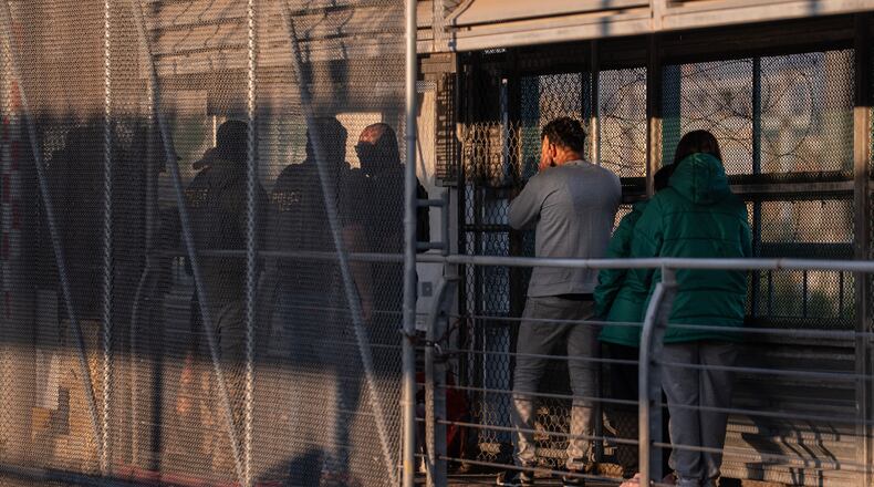 FILE - A group of undocumented migrants is deported by U.S. Immigration and Customs Enforcement agents across the McAllen–Hidalgo–Reynosa International Bridge in McAllen, Texas, March 13, 2026. (AP Photo/Felix Marquez, File)